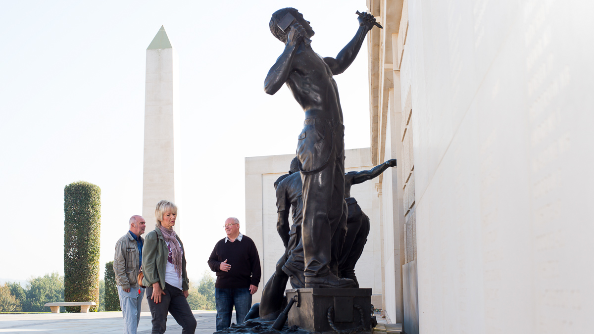 Group admiring statue in National Memorial Arboretum