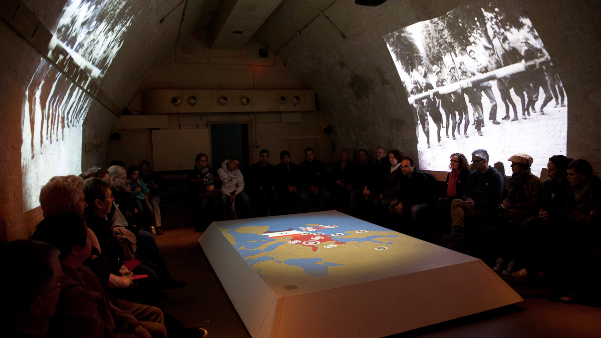 Customers watching projection film in secret war tunnel